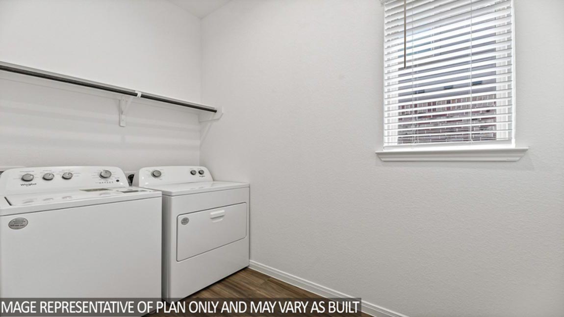 Utility room with vinyl flooring.