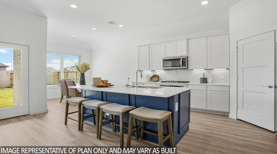 Kitchen with stainless steel appliances and vinyl flooring.