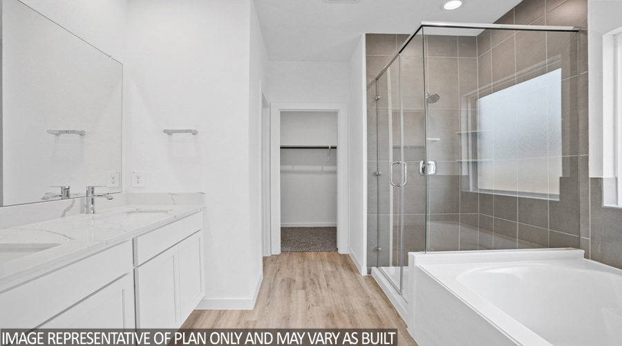 Primary bathroom with vinyl flooring and double sink.
