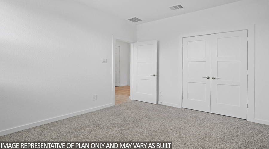 Secondary bedroom with carpet flooring and bright window.