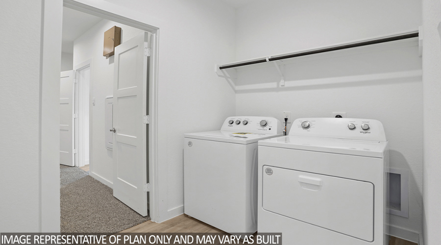 Utility room with overhead storage space.