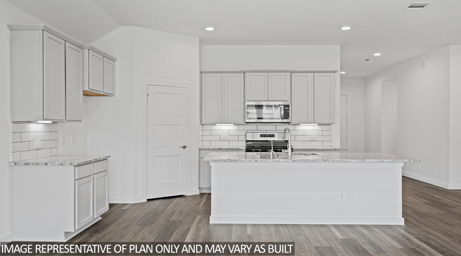 Kitchen with island and stainless steel appliances.