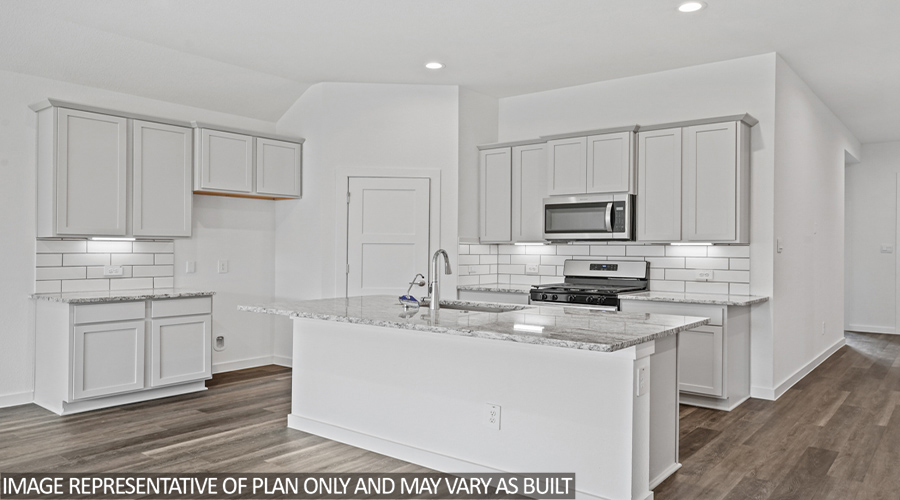 Kitchen with island and stainless steel appliances.