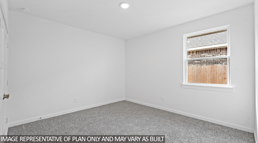 Secondary bedroom with carpet flooring and a bright window.