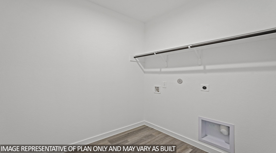 Utility room with overhead storage space.