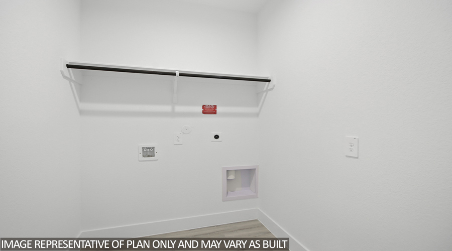 Utility room with overhead storage space.