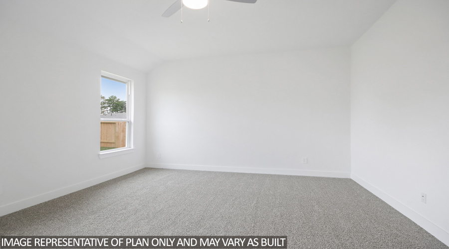 Primary bedroom with carpet flooring.
