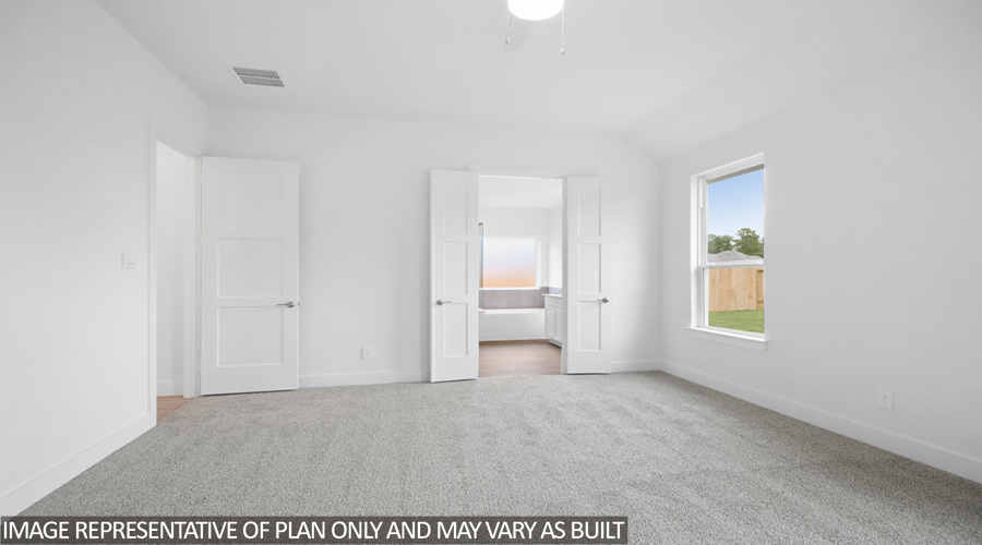 Primary bedroom with carpet flooring.