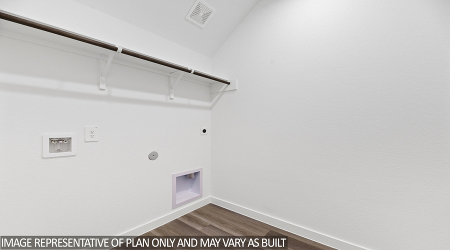 Utility room with overhead storage space.