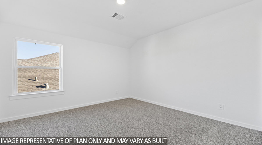 Secondary bedroom with carpet flooring and a bright window.