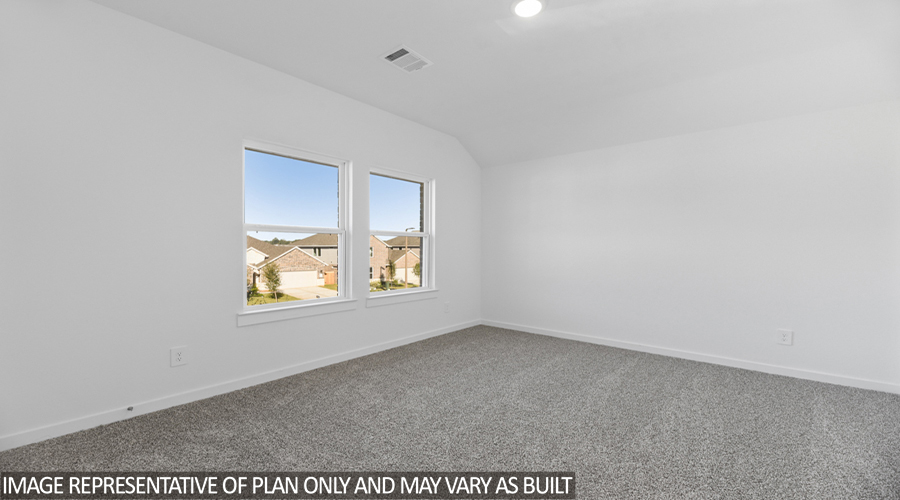 Secondary bedroom with carpet flooring and a bright window.