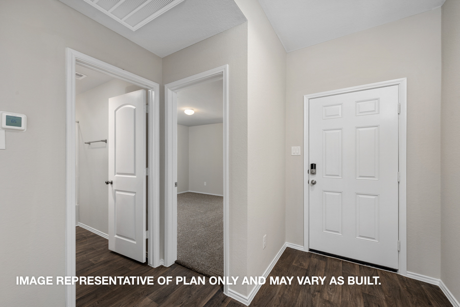 Entryway and foyer with vinyl flooring.