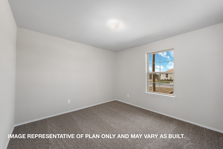 Secondary bedroom with carpet flooring and a bright window.