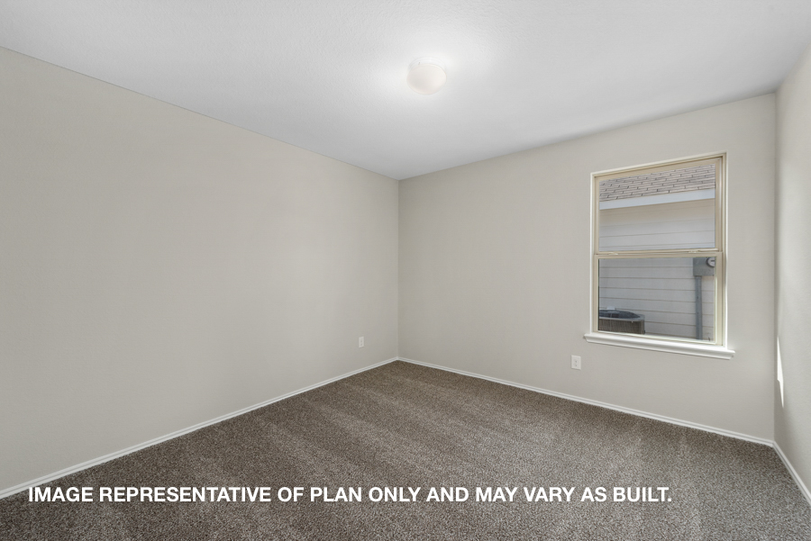 Secondary bedroom with carpet flooring and a bright window.