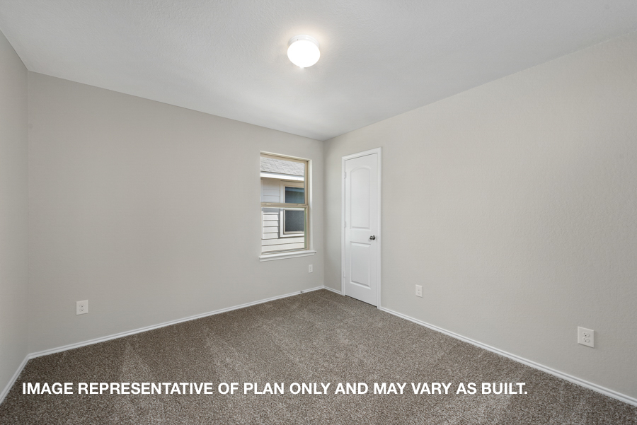 Secondary bedroom with carpet flooring and a bright window.