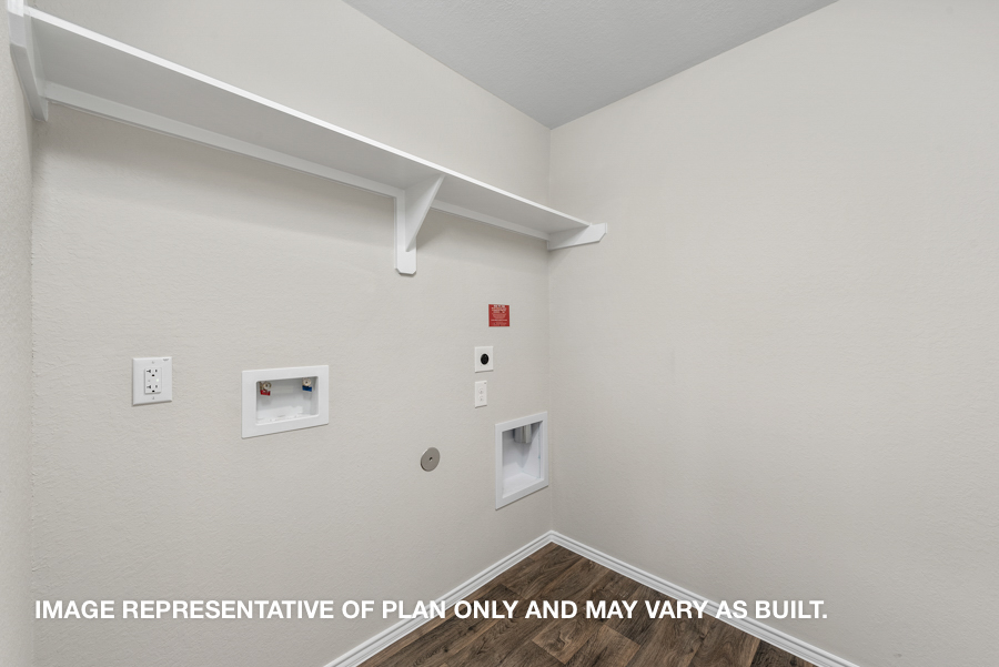 Utility room with overhead storage space.