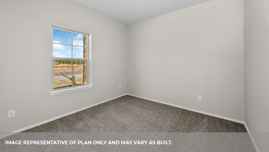 Secondary bedroom with carpet flooring and a bright window.