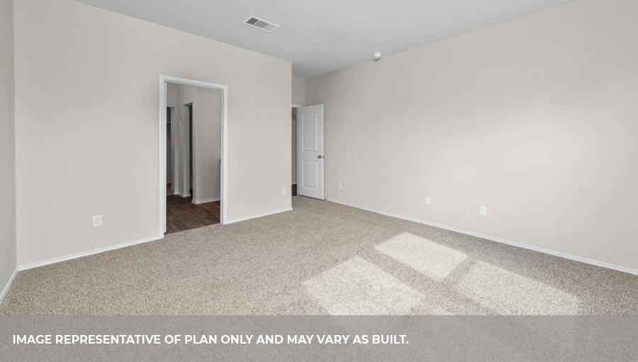 Primary bedroom with carpet flooring.