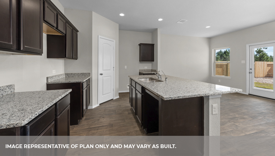 Kitchen with island and stainless-steel appliances.
