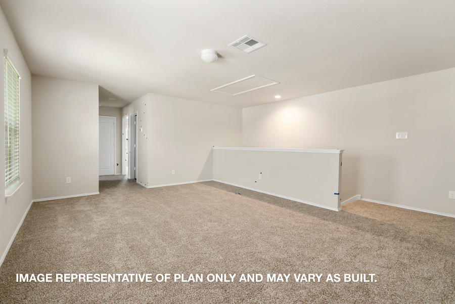 Upstairs game room with carpet flooring and bright windows.