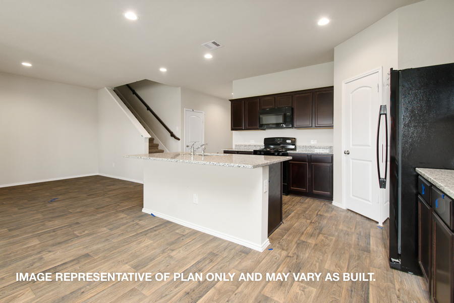 Kitchen with island and stainless-steel appliances.