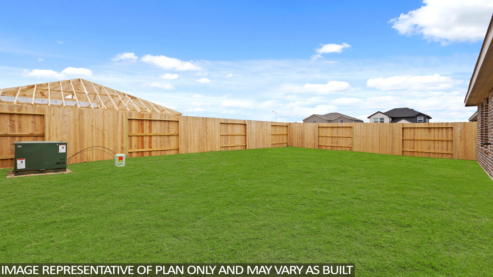 Landscaped backyard with a covered patio.