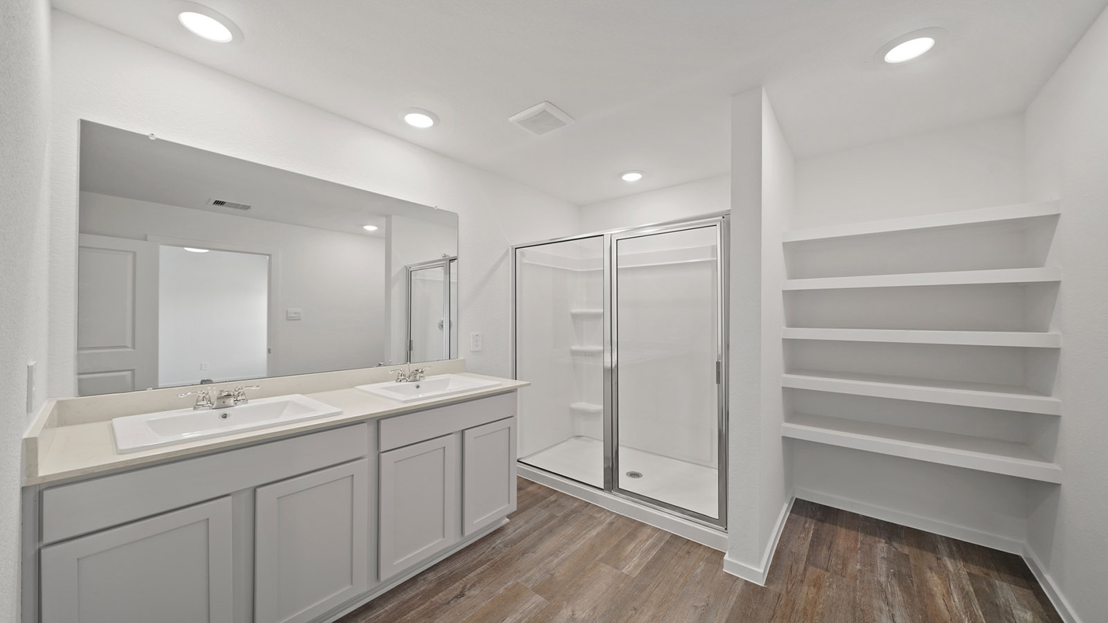 primary bathroom with stand up shower and built in shelving