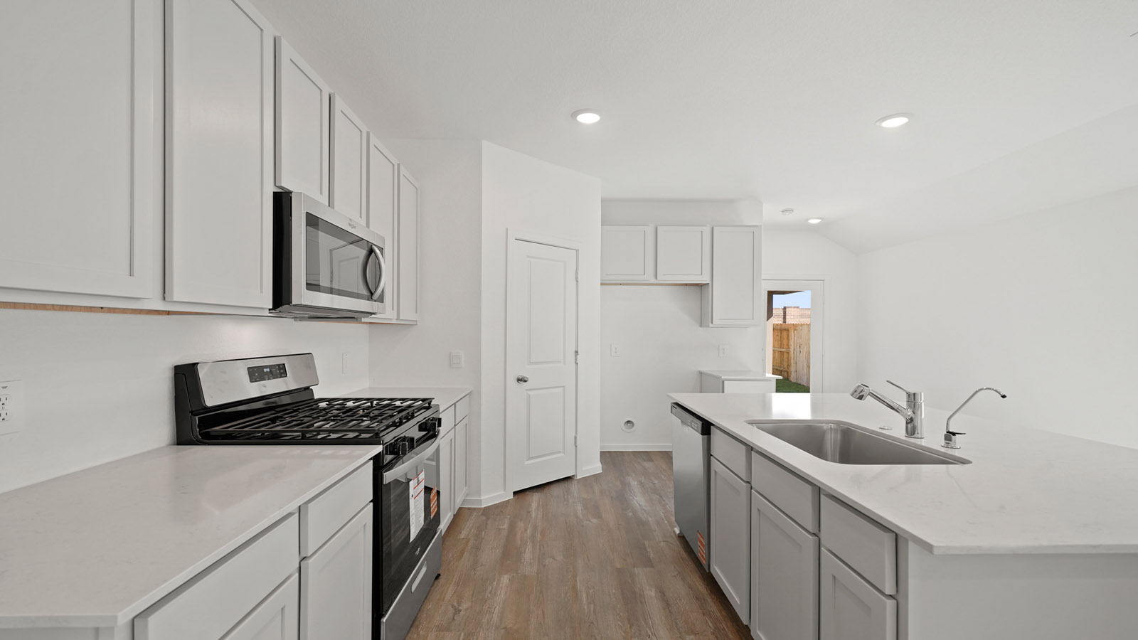 open concept living and dining area with vinyl flooring, quartz countertops, and large windows