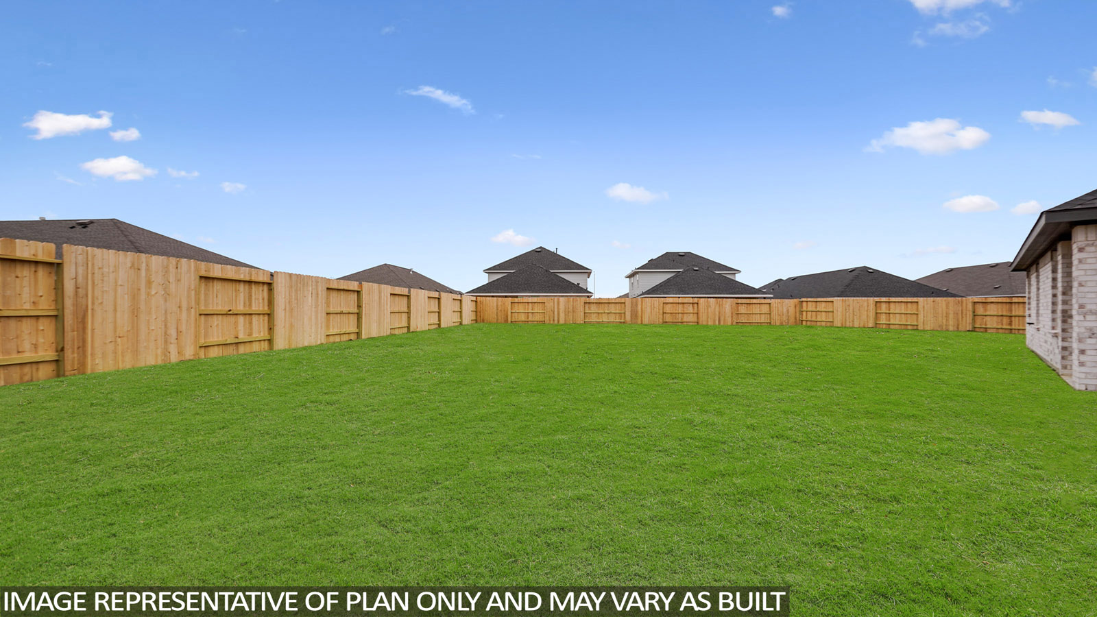 Landscaped backyard with a covered patio.