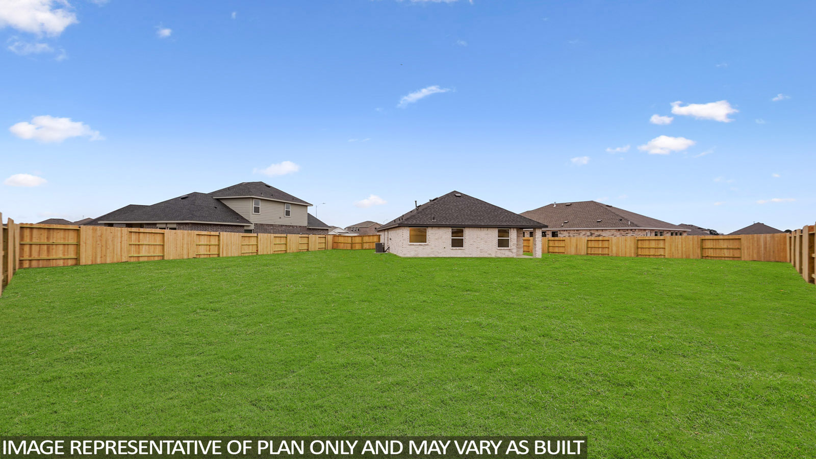 Landscaped backyard with a covered patio.