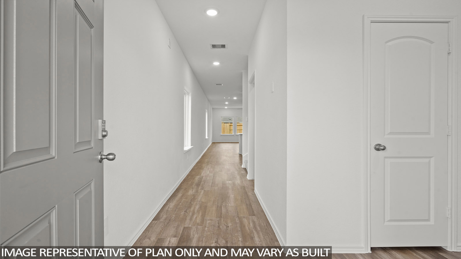 Entry hallway with white walls and vinyl wood flooring.