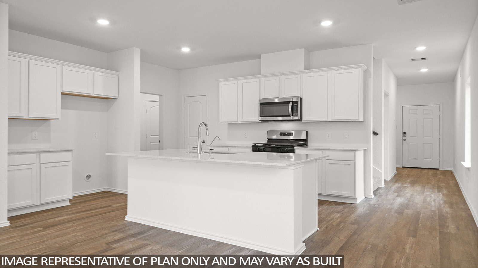 Open kitchen with an island, stainless steel appliances, white cabinets, white walls, and vinyl wood flooring.