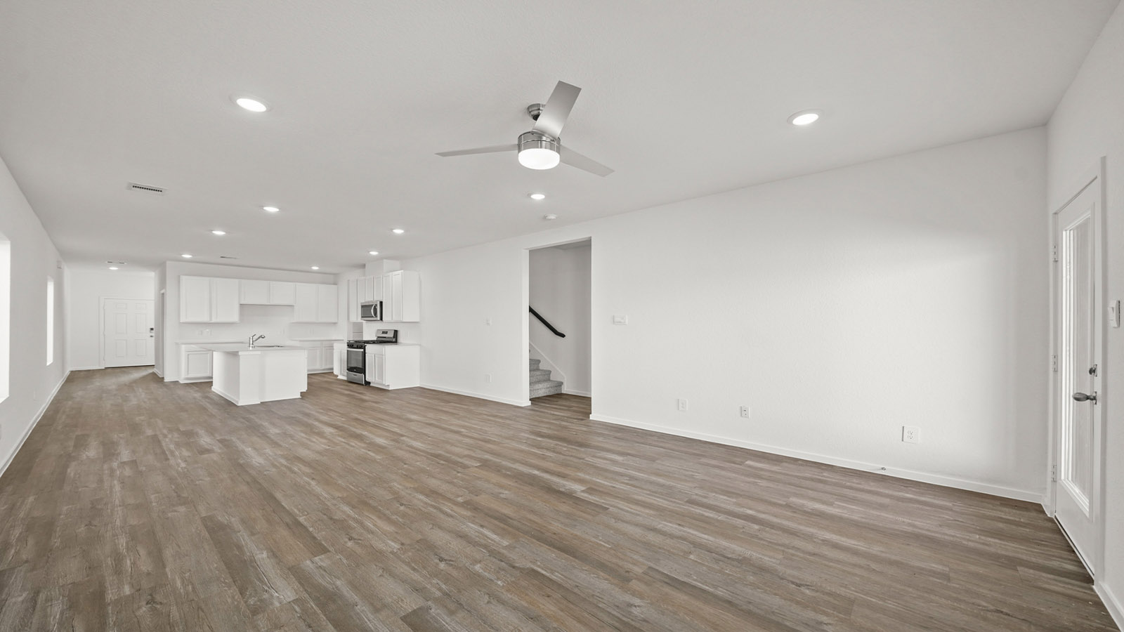 open concept living and dining area with vinyl flooring