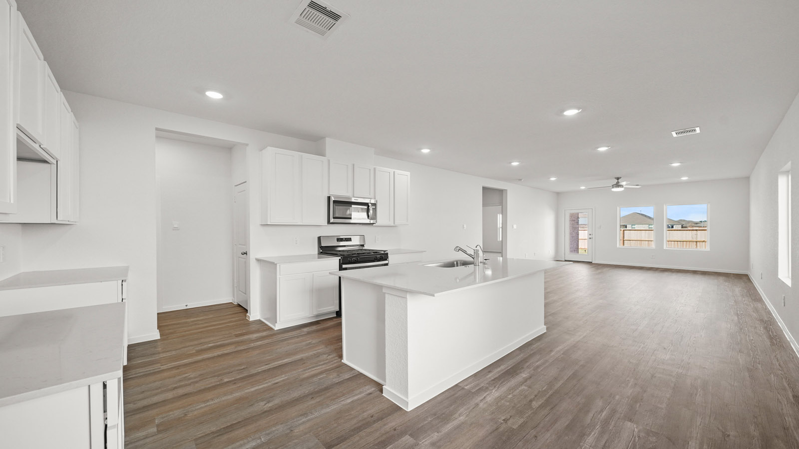open concept living and dining area with vinyl flooring