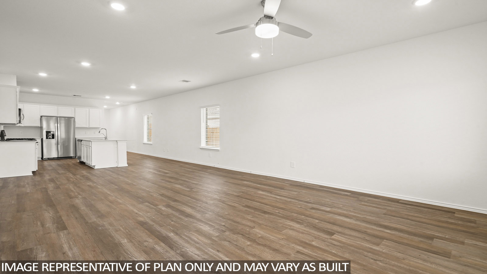 Open living room with windows, white walls, and vinyl wood flooring.