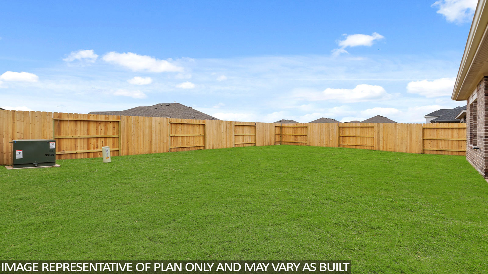 Landscaped backyard with a covered patio.