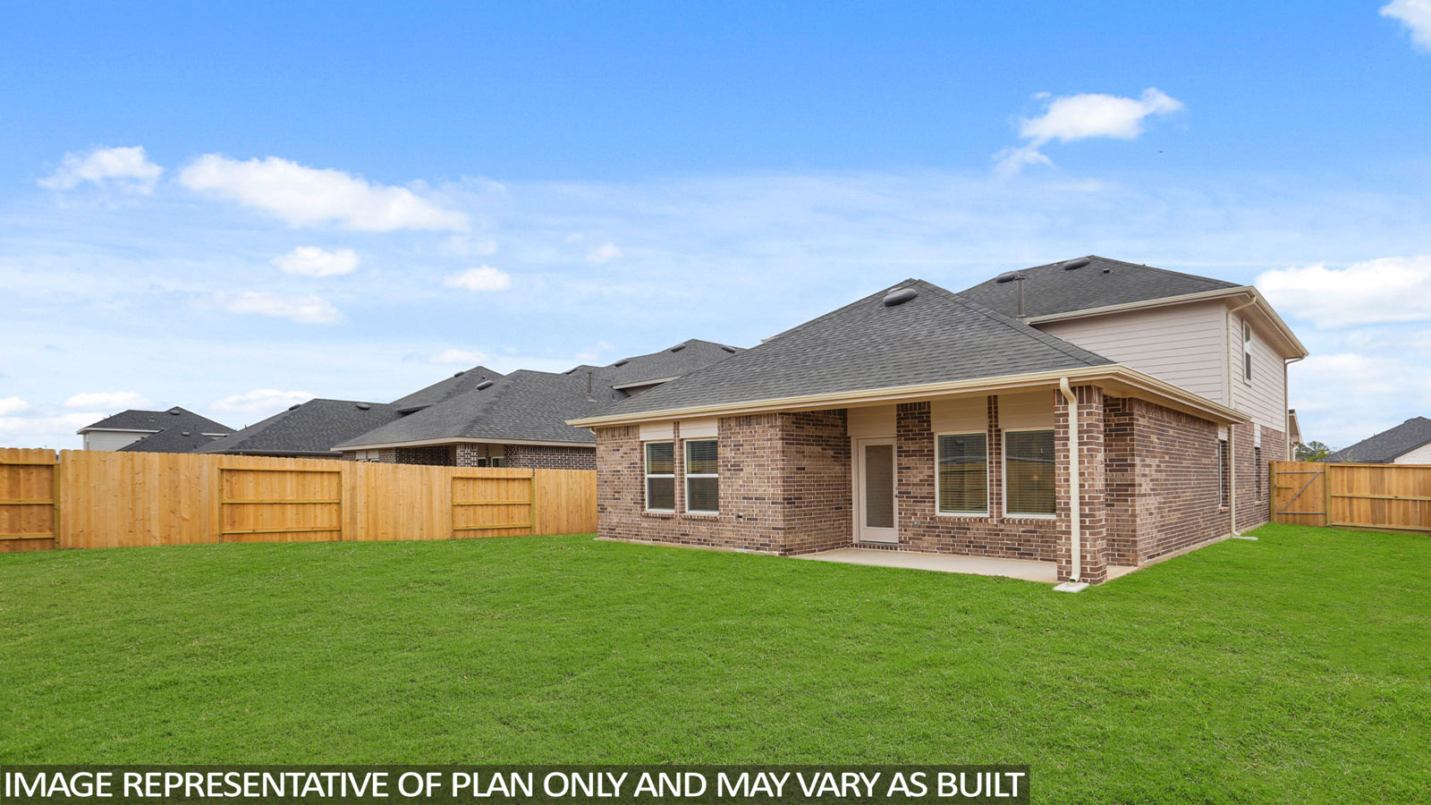 Landscaped backyard with a covered patio.