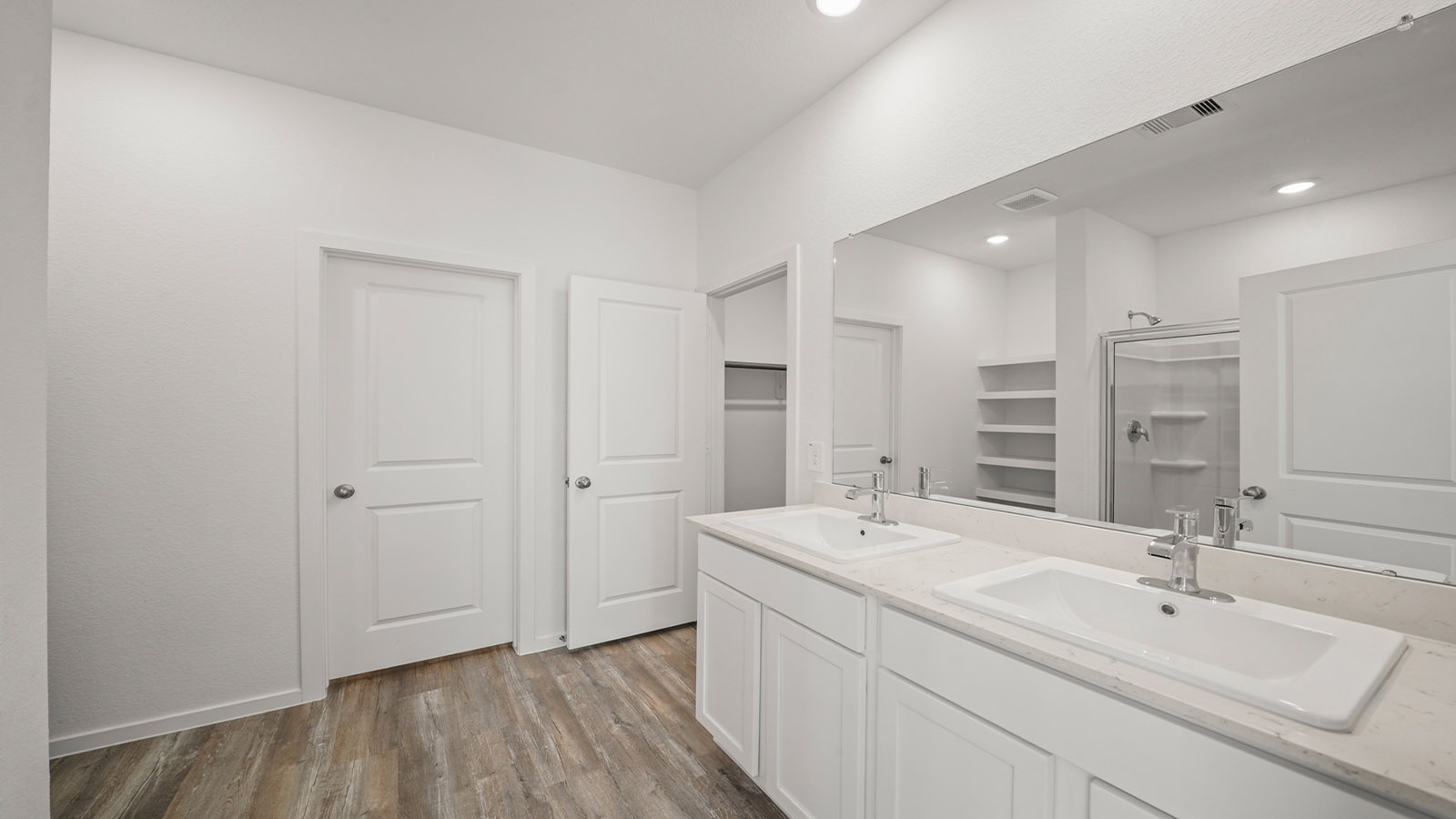 Owner’s ensuite in a new build home offers function and style with a walk-in closet, spa-like ensuite