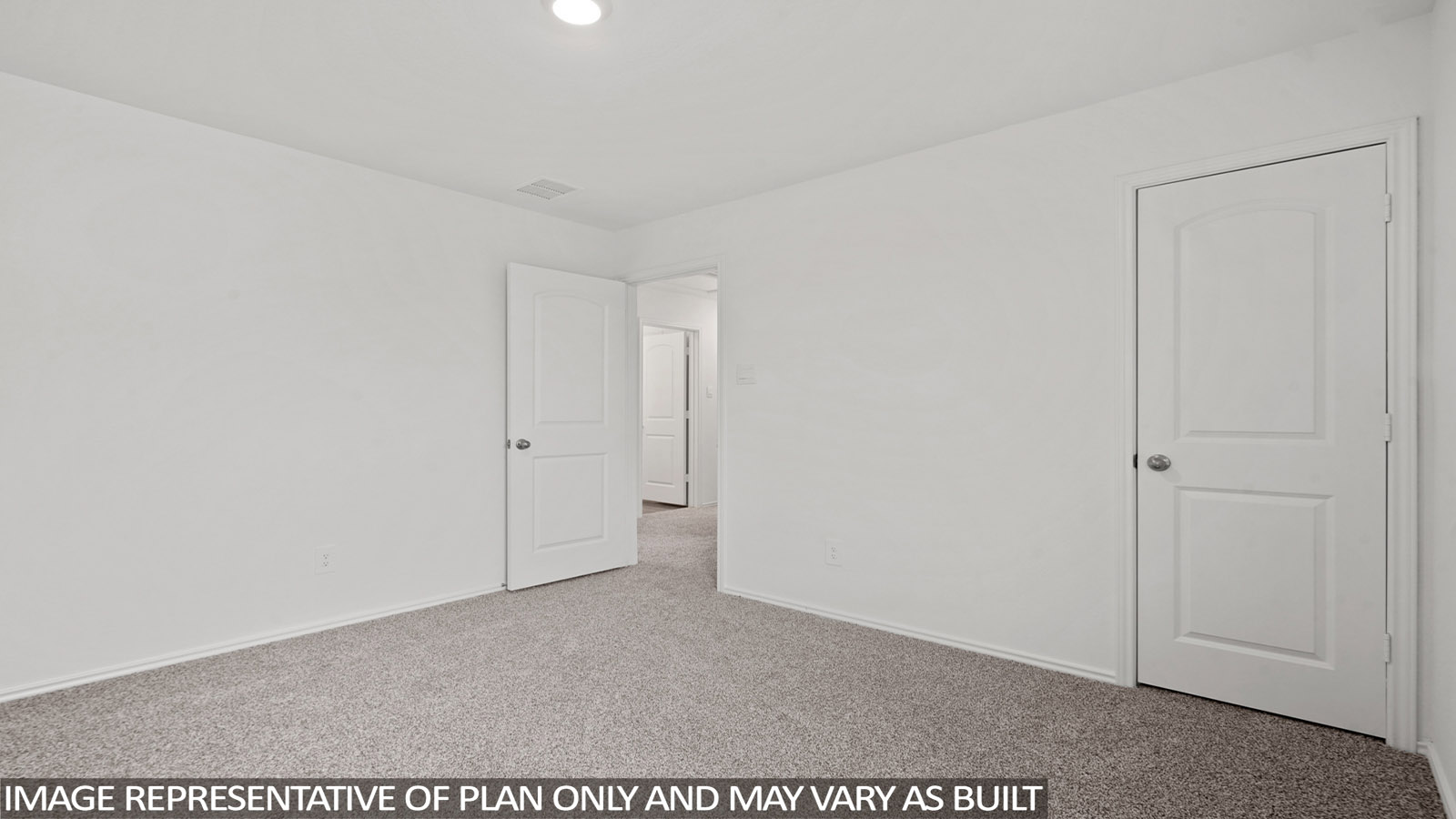 Secondary bedroom with windows, white walls, and light carpet.