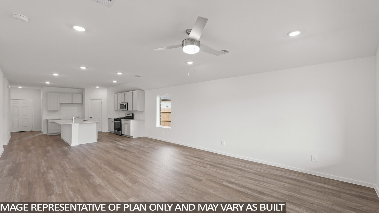 Spacious living area with vinyl flooring