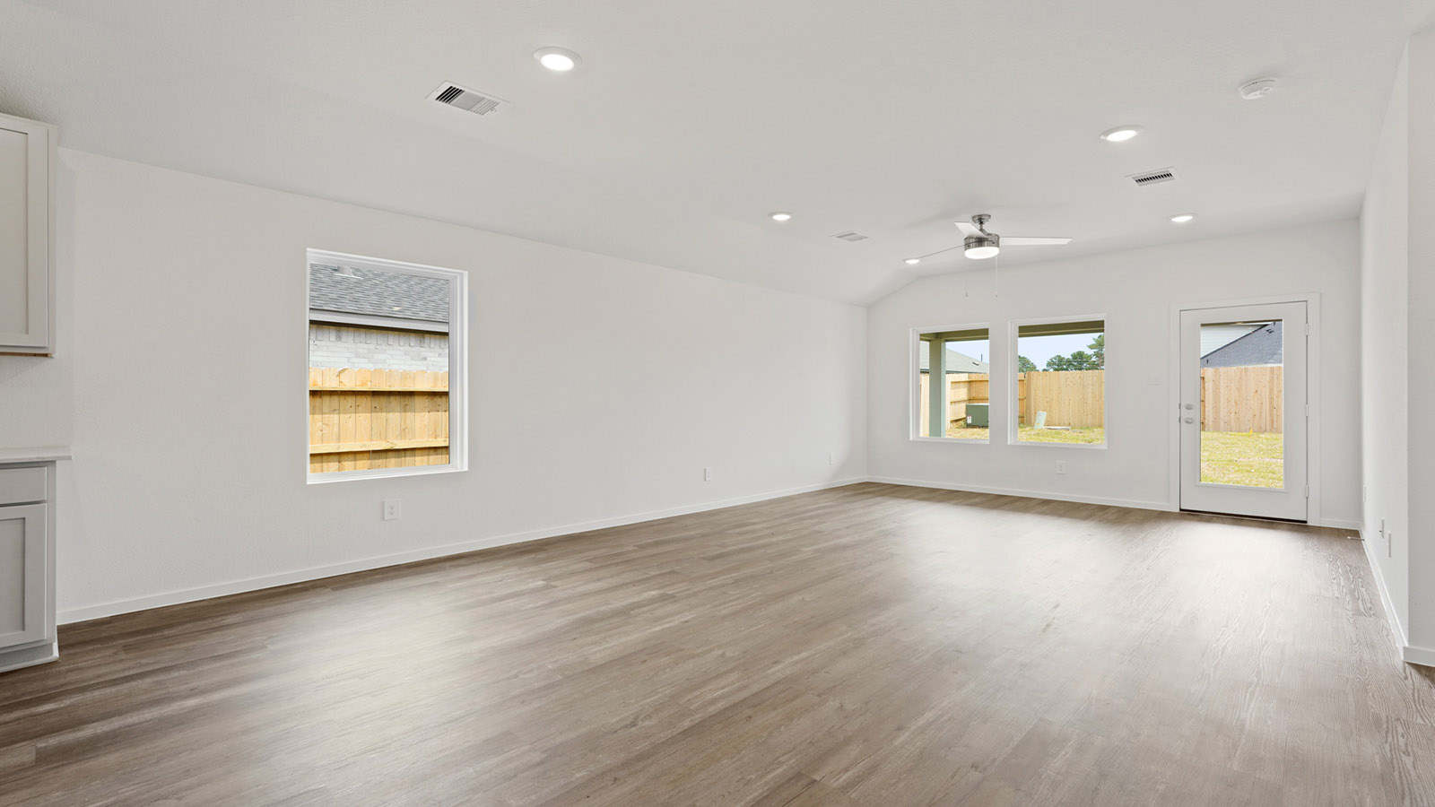 open concept living and dining room with vinyl flooring