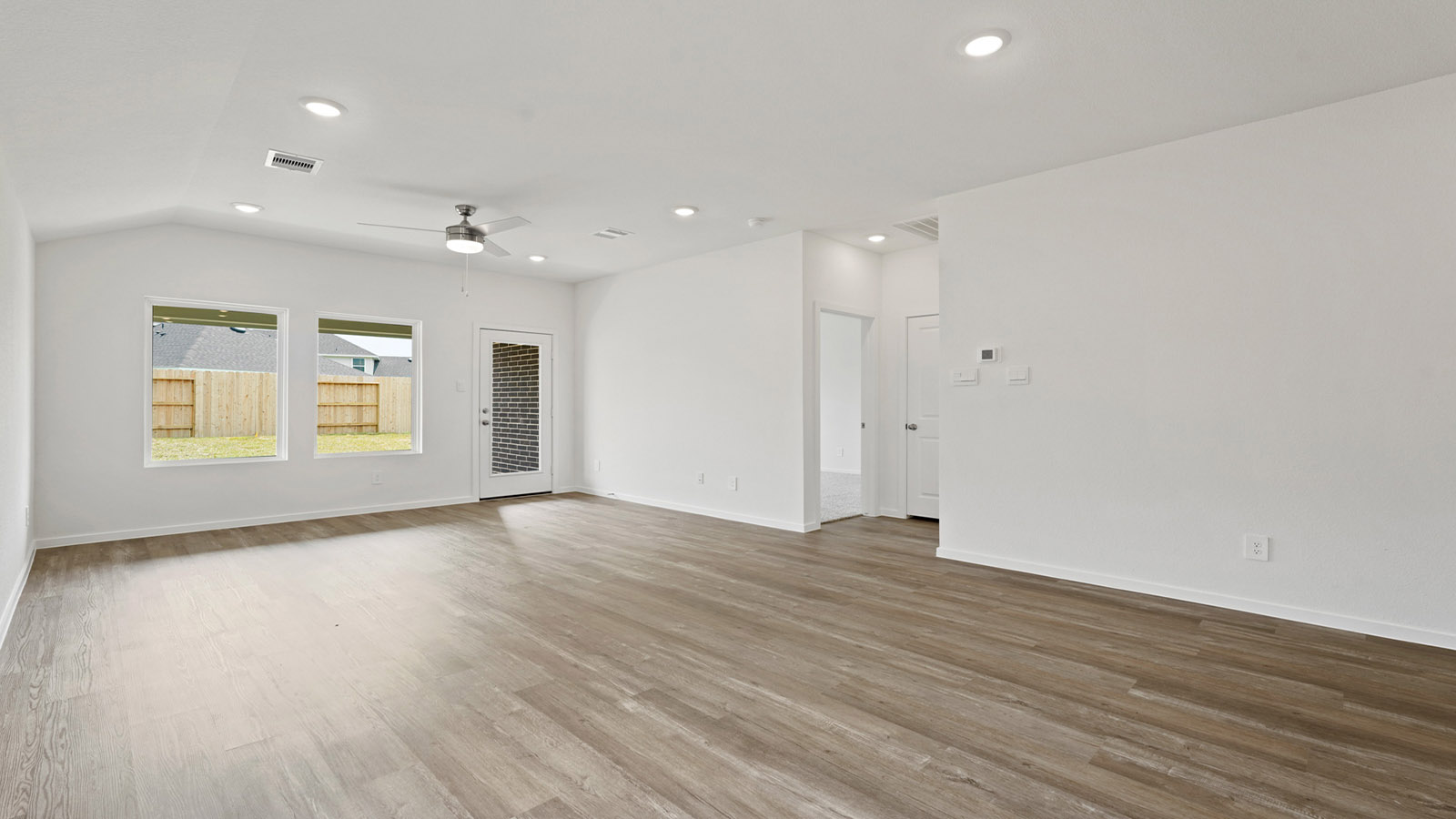 open concept living and dining room with vinyl flooring
