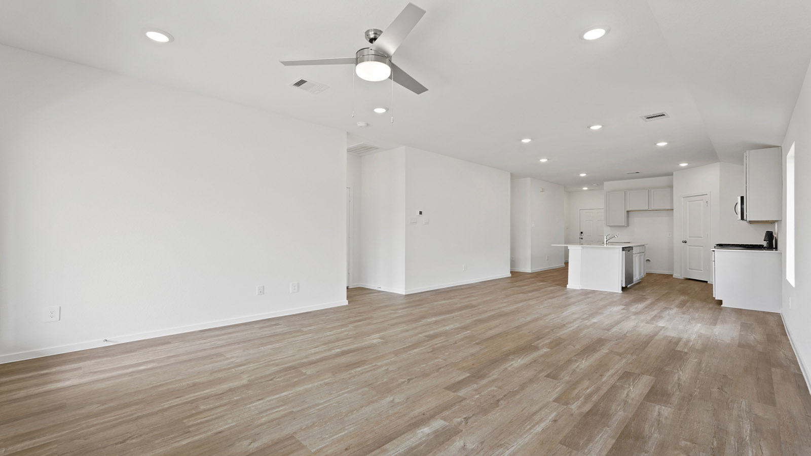 open concept living and dining room with vinyl flooring