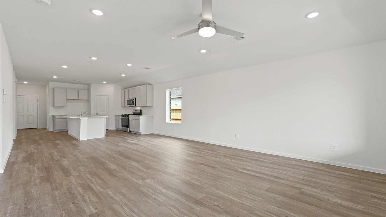 open concept living and dining room with vinyl flooring