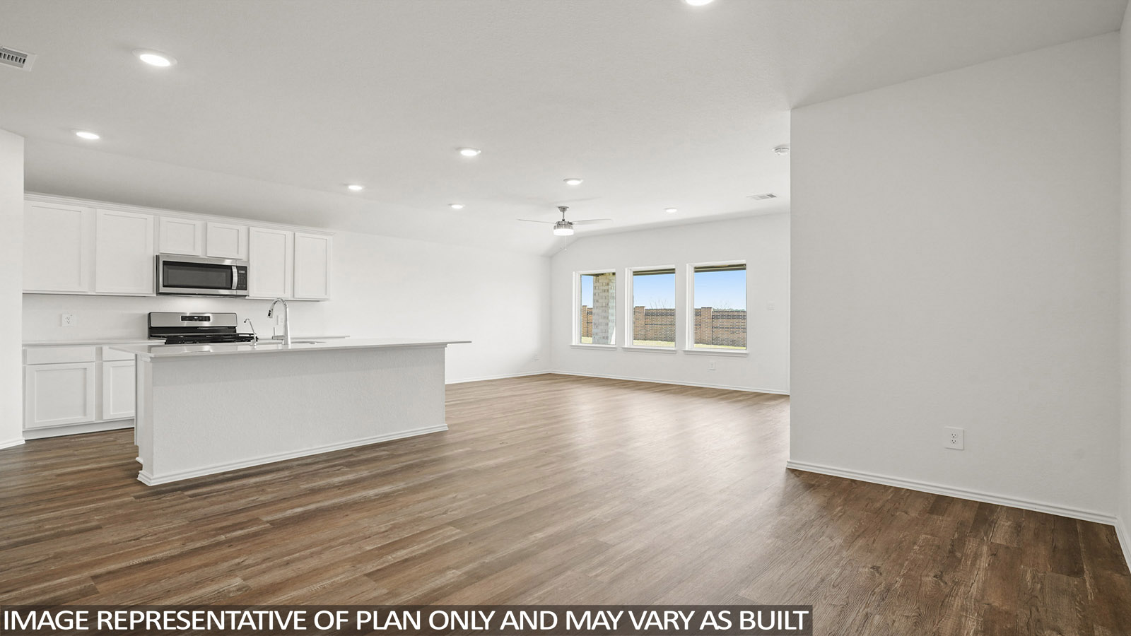 Open living room with windows, white walls, and vinyl wood flooring.