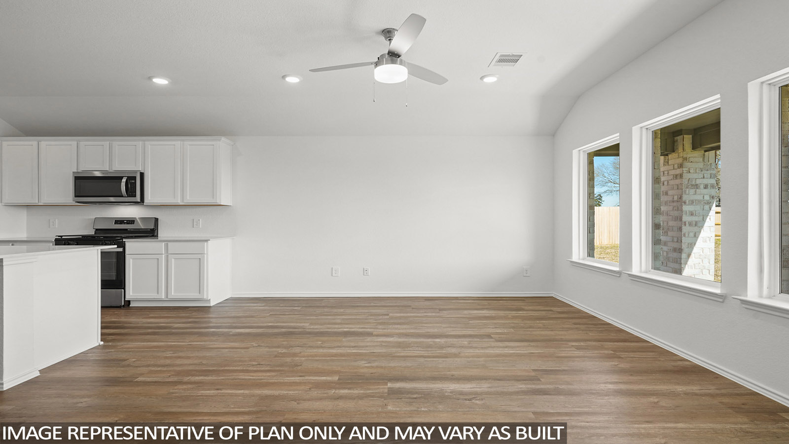 Open living room with windows, white walls, and vinyl wood flooring.