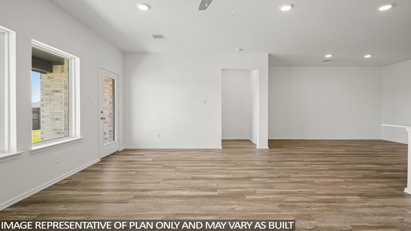 Open living room with windows, white walls, and vinyl wood flooring.