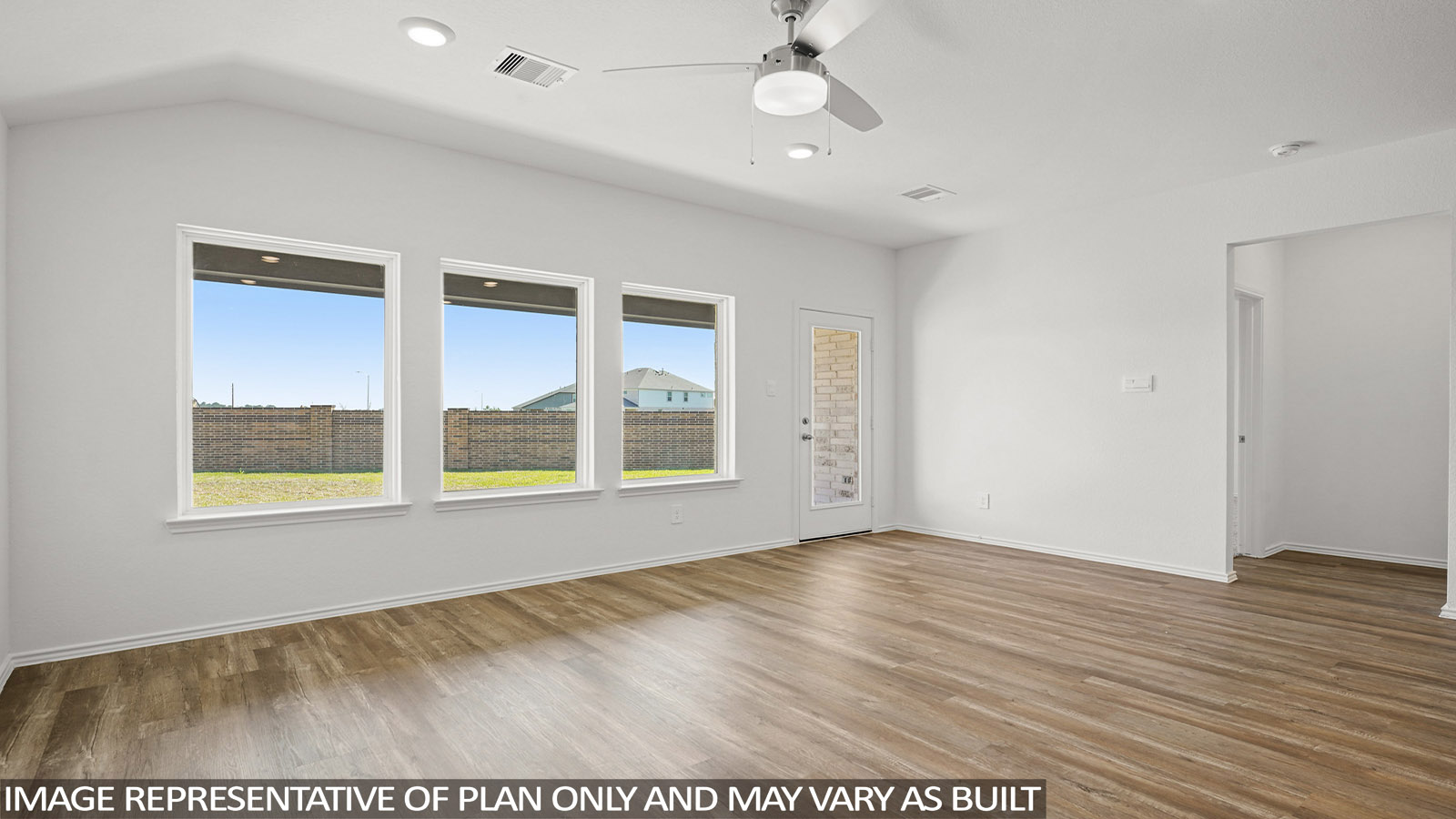 Open living room with windows, white walls, and vinyl wood flooring.