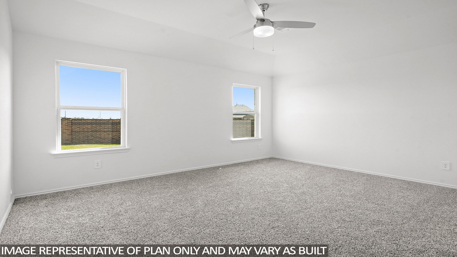 Primary bedroom with windows, white walls, and light carpet.