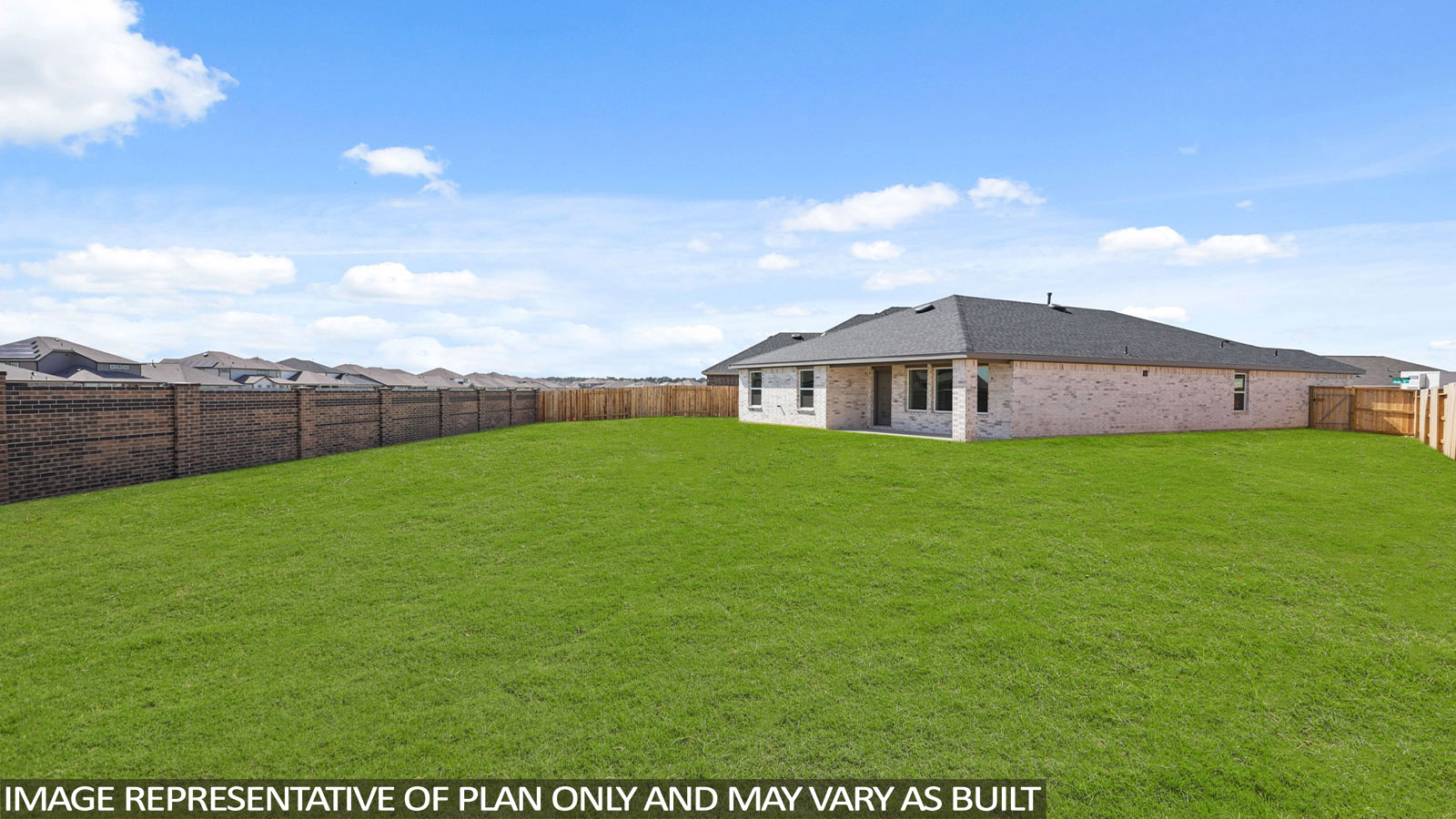 Landscaped backyard with a covered patio.